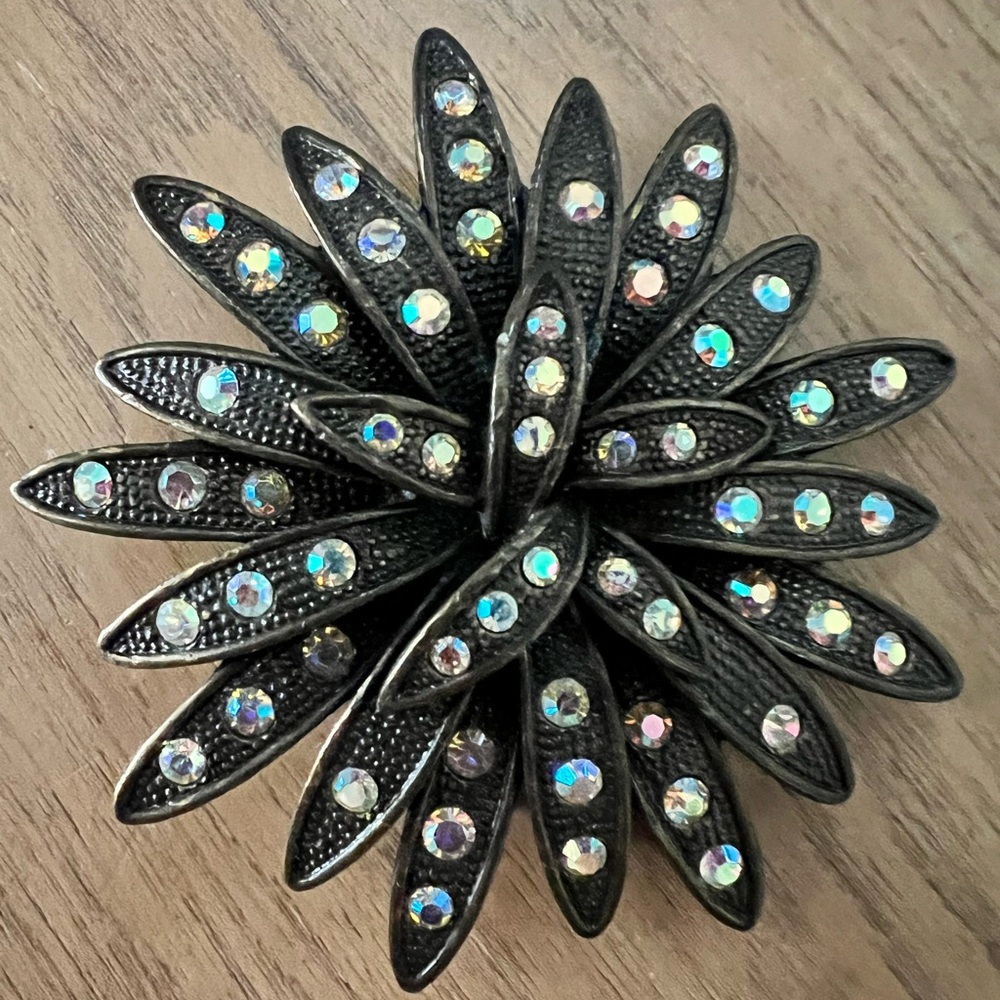 Bronze vintage floral starburst brooch with AB coated rhinestones. 2.5” diameter
